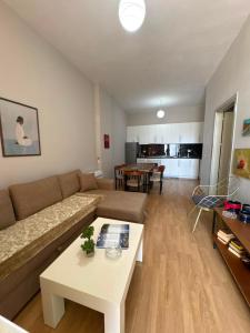a living room with a couch and a table at Alex Apartment in Pogradec