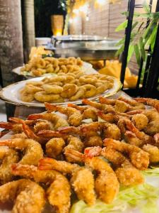 a buffet with several plates of food with shrimp at Castle View Hotel Resort in Samal
