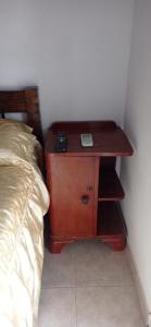 a night stand next to a bed in a room at Del Centro Dptos in Federación