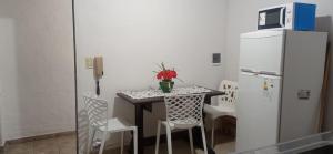 a small kitchen with a table and a refrigerator at Del Centro Dptos in Federación