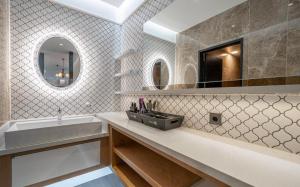 a bathroom with a sink and a tub and a mirror at Andong Win Hotel in Hoam-dong +45 photos