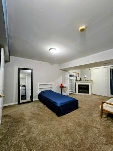 a bedroom with a blue bed and a fireplace at MALE Only Shared Basement in Frederick