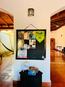 a wall with a bulletin board in a room at Sunrise Guest House in León