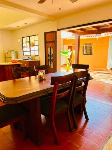 a dining room with a wooden table and chairs at Sunrise Guest House in León