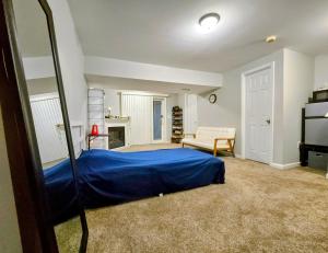 a bedroom with a blue bed and a mirror at MALE Only Shared Basement in Frederick