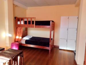 a bedroom with two bunk beds and a refrigerator at Casa Sajama 121 in La Paz