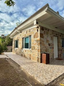 a stone house with a window and a roof at Cabañas El Itali in Fusagasuga