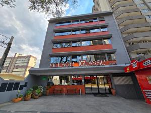 a building with a sign that reads village cesarlez at Village Iguassu Hotel in Foz do Iguaçu