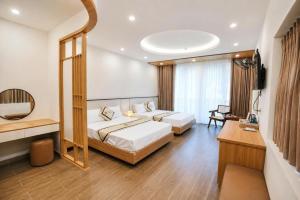 a hotel room with two beds and a mirror at TherHouse in Mộc Châu
