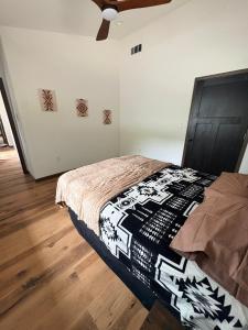a bedroom with a bed in a room with wooden floors at Driftless Destinations in McGregor