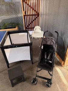 a stroller and a baby cart in a garage at Private sanctuary between river and sea in Perth