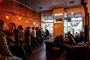 a group of people sitting in a restaurant at Private sanctuary between river and sea in Perth +18 photos