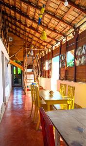a dining room with a wooden table and chairs at Hostel La Ballena Backpacker in Las Galeras