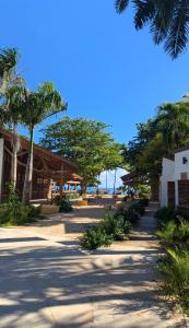 a street with palm trees and a building at Hostel La Ballena Backpacker in Las Galeras