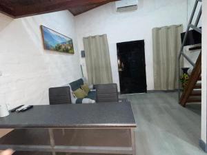 a living room with a couch and a table at Mini Loft en Quezaltepeque in Quezaltepeque
