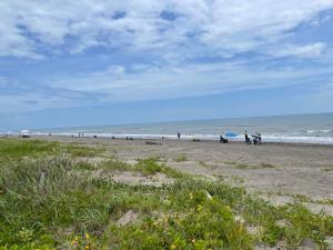 a group of people walking on the beach at Departamento al lado del Mar in Barra Nueva +3 photos