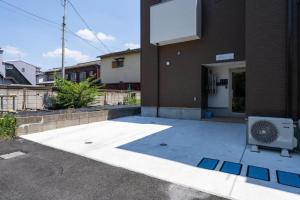 a building with a fan sitting outside of it at Norah Stay Tokyo in Yashio