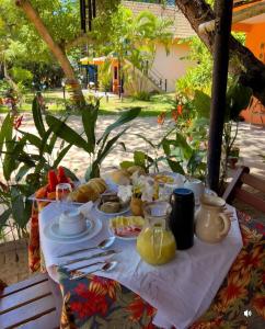 a table with food and drinks on top of it at Cajibá Imbassai in Imbassai