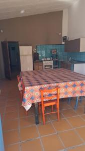 a kitchen with a table with a table cloth on it at Casa con bajada al rio in Villa Cura Brochero