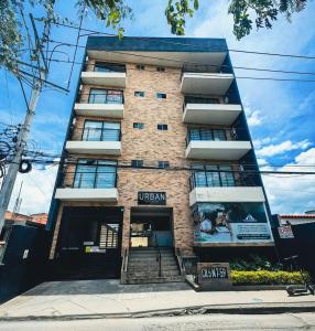 a tall brick building with the front door open at Edificio Urban in Cajicá