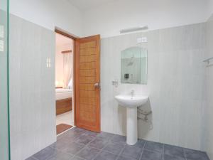 a bathroom with a sink and a mirror at Kandy 888 Villa in Kandy +60 photos