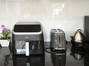 a blender and a toaster sitting on a counter at Kandy 888 Villa in Kandy