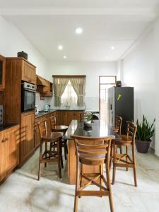 a kitchen with a table and chairs and a refrigerator at Kandy 888 Villa in Kandy