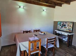 a table with chairs and a bowl of fruit on it at Vertiente escondida in Villa Yacanto +7 photos
