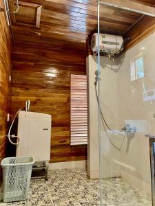 a bathroom with a shower and a fan at COZY HOME PHU QUOC in Phú Quốc +33 photos