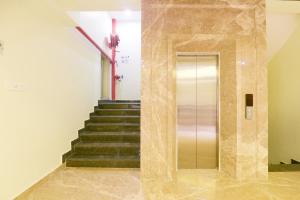 a elevator in a building with a staircase at Super OYO 77736 Hotel Starlight in Kānpur