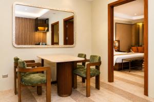 a dining room with a table and chairs and a mirror at Coron Westown Resort in Coron