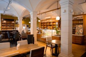 a restaurant with tables and chairs and a bar at Central Mansions Hotel and Apartments in Phnom Penh