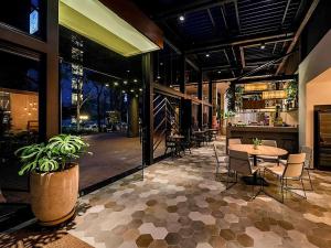 a restaurant with a table and chairs in a building at Grand Mercure Itaim Bibi | Premium & Luxury Flat in São Paulo