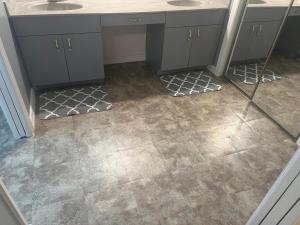 a bathroom with two sinks and a tile floor at Hutchinson River House in Fort Pierce +32 photos