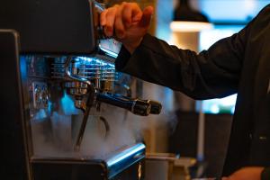 a person is making something in a machine at Hotel Resol Trinity Kyoto in Kyoto