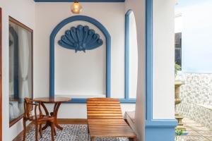 a table and chairs in a room with blue trim at Trương Nhi Bungalow in Phú Quốc