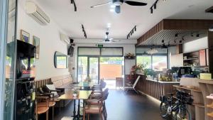 a restaurant with tables and chairs in a room at Xan hotel in Phú Quốc