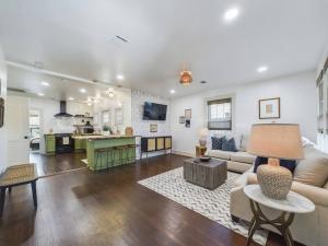 a living room and kitchen with a couch and a table at Buchanan Bungalow - Eclectic Mid-Mod Design DT in Lafayette +26 photos