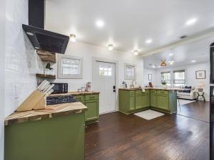 a kitchen with green cabinets and a counter top at Buchanan Bungalow - Eclectic Mid-Mod Design DT in Lafayette