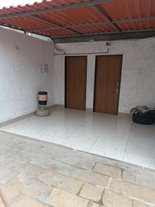 an empty room with two doors in a building at Shiva Homestay Dwarka in Dwarka