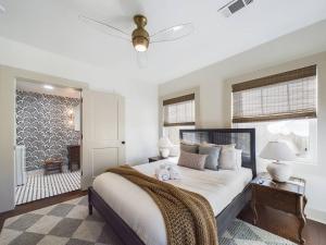 a bedroom with a large bed with a ceiling fan at Buchanan Bungalow - Eclectic Mid-Mod Design DT in Lafayette