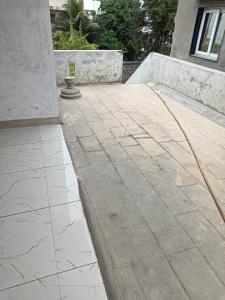 a concrete patio with a hose on it at Shiva Homestay Dwarka in Dwarka
