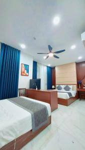 a bedroom with two beds and a ceiling fan at Xan hotel in Phú Quốc