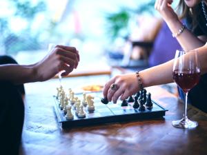 two people playing a game of chess on a table at 30 PIECES Namba in Osaka