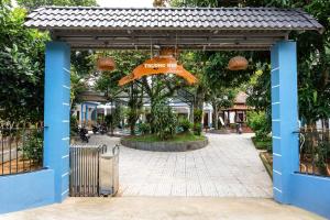 an open gate with a sign that says honeymitemite at Trương Nhi Bungalow in Phú Quốc