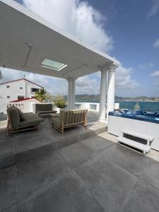 a patio with two chairs and a swimming pool at FIG PARADIS the villa in Philipsburg