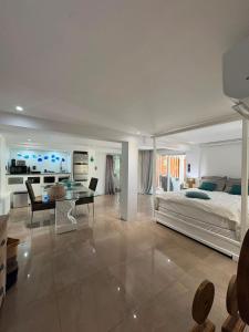 a large bedroom with a bed and a table at FIG PARADIS the villa in Philipsburg
