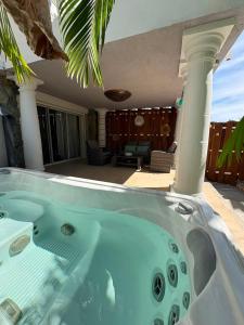 a hot tub on the patio of a house at FIG PARADIS the villa in Philipsburg +22 photos