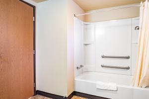 a bathroom with a shower and a bath tub at City Inn in Westminster