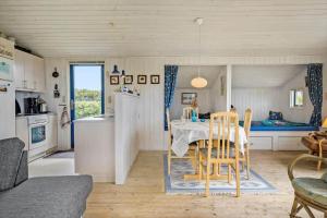 a kitchen and living room with a table and chairs at G112-Lemvig-Anemonevej-12 in Lemvig